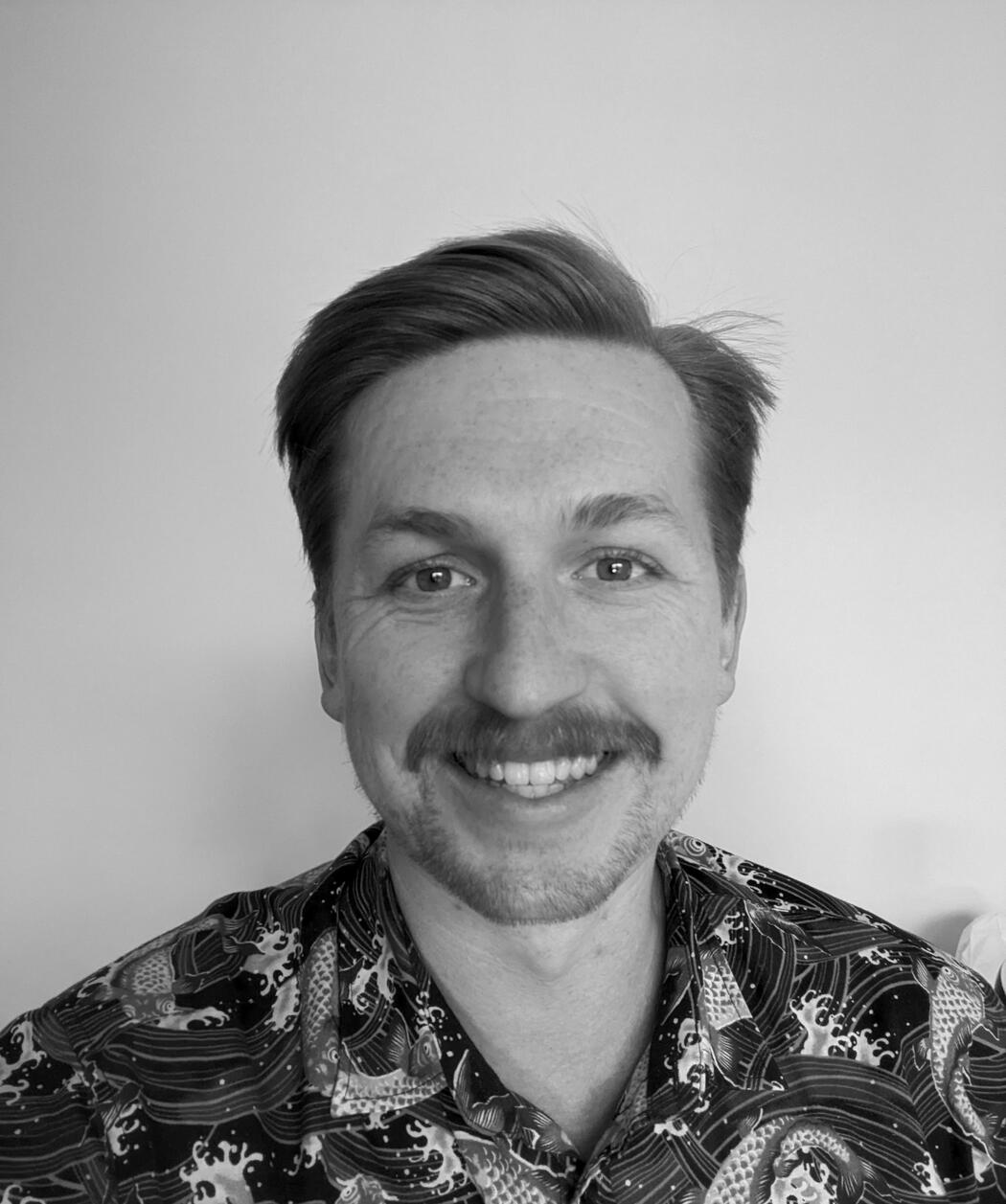 A headshot showing Jamie Fawcett smiling to camera.